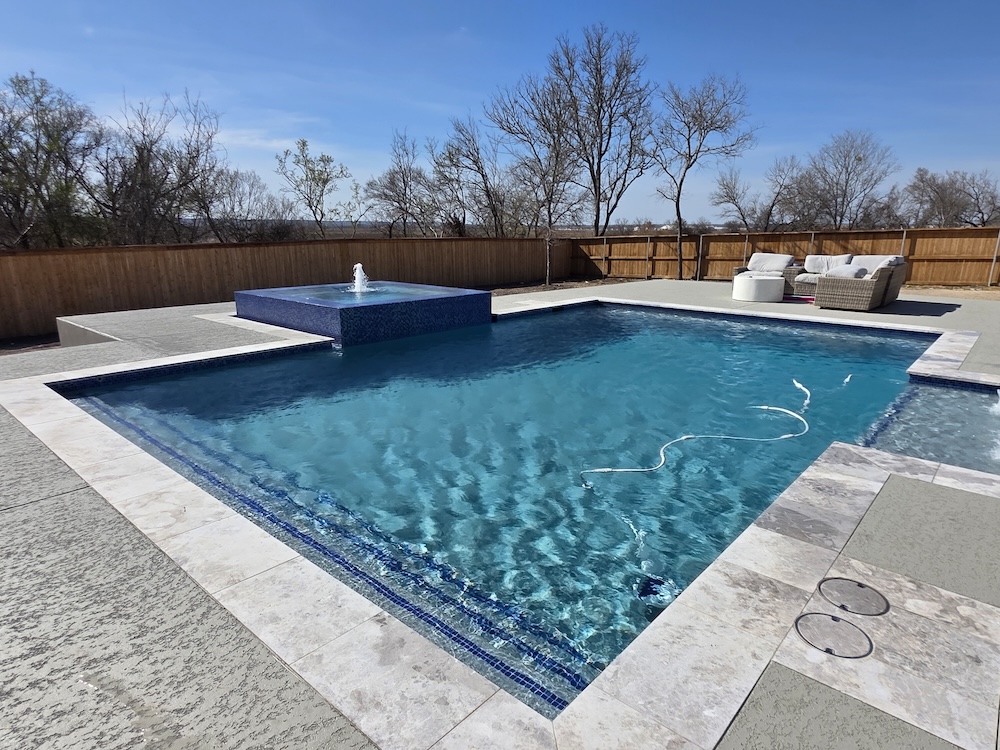 Modern pool with blue mosaic spa